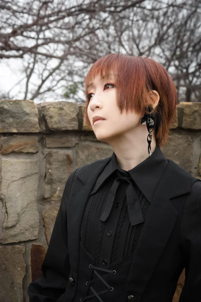Professional headshot of Emi Lo smiling or posing for a convention portrait